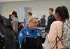 Airport ASSAULT: Attacker SLAMS TSA Agent, Federal Charges Filed TSA agent checks passengers documents at airport security.