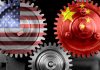 Interlocking gears with USA and China flags.