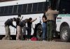 ICE Arrests to “Explode Greatly” in 2026 Border patrol officers investigating people near a bus.