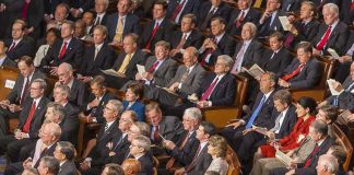 Dems Goes Rogue – Hegseth Impeachment Incoming Audience of officials sitting and reading documents in auditorium.
