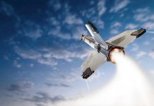 SpaceX Rockets Rewrite Military Logistics Rocket launching into the sky with clouds.