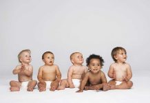Russian Billionaire’s Shocking 100 Kids Revelation Five diverse babies sitting on a neutral background, displaying playful expressions