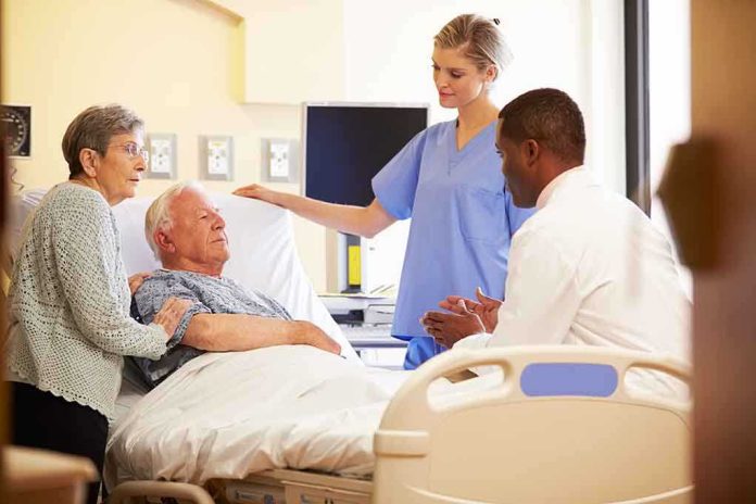 shutterstock_168773126.jpg A nurse and a doctor discussing with a patient and his family in a hospital room
