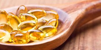 Alzheimer’s Risk DOUBLES With This Common Deficiency Golden omega-3 capsules in a wooden spoon
