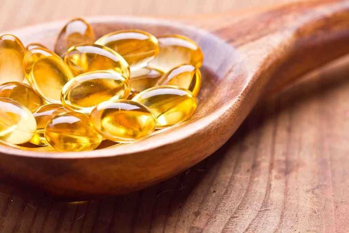 shutterstock_175262174.jpg Golden omega-3 capsules in a wooden spoon
