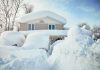 A house surrounded by deep snow drifts after a heavy snowfall