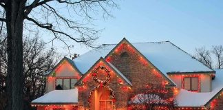 Homeowner THREATENS Christmas Carolers With GUN A beautifully decorated house with Christmas lights in a snowy setting