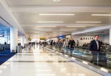 People walking through a busy airport terminal.