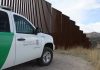 Democrats Deportation Double Standards – Unbelievable! Border protection vehicle near a large metal fence.