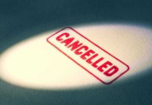 Red Cancelled stamp under a spotlight.