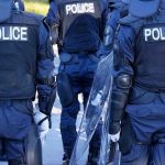 LAPD Caught in Weapon Use Scandal Police officers in riot gear with shields.