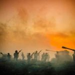Soldiers and tanks in the foggy battlefield.