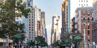 City street with pedestrian crossing and traffic.