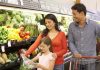 A family shopping for fresh vegetables in a grocery store