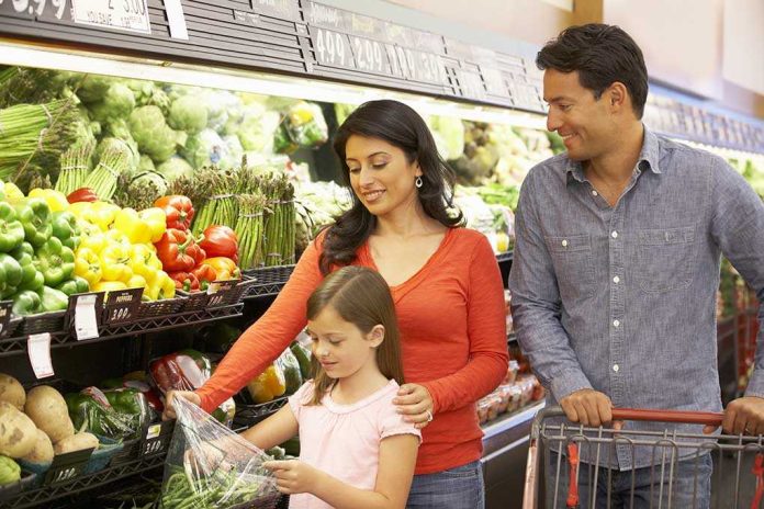 A family shopping for fresh vegetables in a grocery store