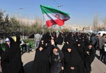 Iran’s Leader Plans SHOCKING Moscow Escape Group of women in black attire marching with an Iranian flag