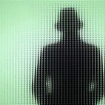 Police Weaponize YOUR Own Face Silhouette behind frosted, textured glass in green light.