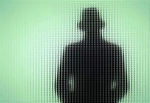 Silhouette behind frosted, textured glass in green light.