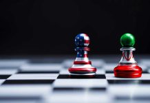 Chess pieces with USA and Iran flags on board.