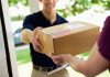 A delivery person handing a package to a customer at their doorstep