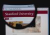IDEOLOGY Pledge Required For Stanford’s Seat Close-up view of Stanford Universitys website through a magnifying glass