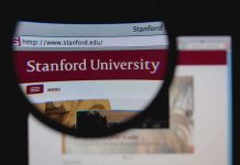 IDEOLOGY Pledge Required For Stanford’s Seat Close-up view of Stanford Universitys website through a magnifying glass
