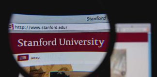 Close-up view of Stanford Universitys website through a magnifying glass
