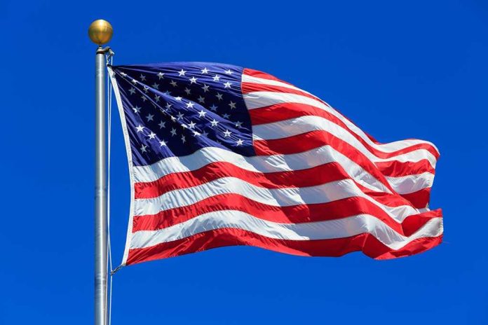 Waving American flag against a clear blue sky