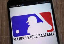 Robot Strike Call Reversed—Manager Loses It Major League Baseball logo on a smartphone screen.