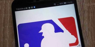 Robot Strike Call Reversed—Manager Loses It Major League Baseball logo on a smartphone screen.