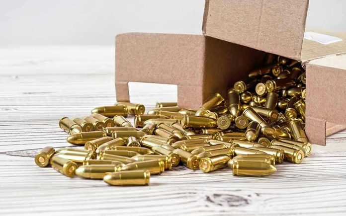 1477517537 Box of brass bullets spilled on wooden surface.