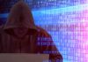 Hackers Steal Codes From Top Officials Person in hoodie using laptop, surrounded by digital code.