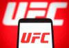 White House BANS UFC Fighter After Outburst UFC logo on phone screen and background.
