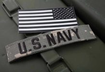 Navy Pilot’s SHOCKING Ramadan Visit Exposed U.S. Navy patch with black-and-white American flag.