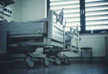 Insider Threat EXPLODES at Renowned Cancer Hospital Empty hospital beds by a window.