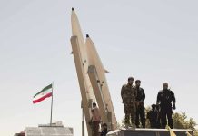 Deadly Iran Retaliation – Nobody Expected THIS Military personnel beside missiles and Iranian flag.