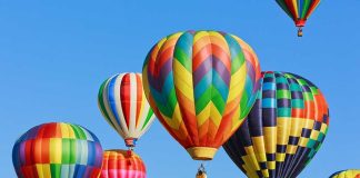 Colorful hot air balloons floating in a clear blue sky