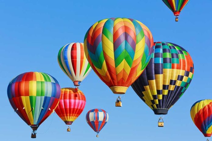 shutterstock_156212846.jpg Colorful hot air balloons floating in a clear blue sky