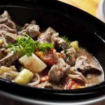 A hearty beef stew with vegetables in a slow cooker