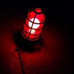 A red lantern emitting a warm glow in a dark setting