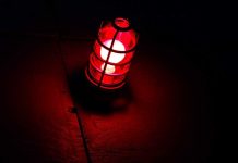 A red lantern emitting a warm glow in a dark setting
