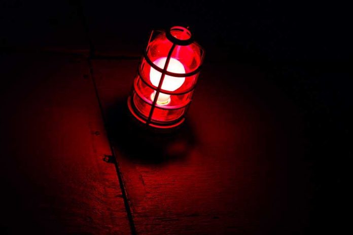 A red lantern emitting a warm glow in a dark setting