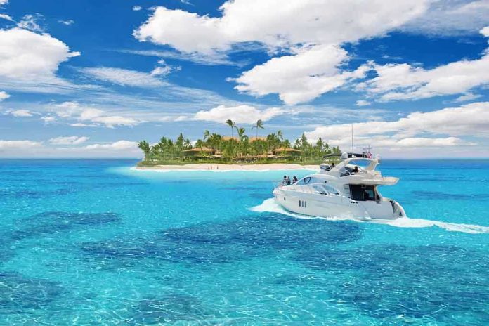 A luxury yacht cruising in clear blue waters near a tropical island