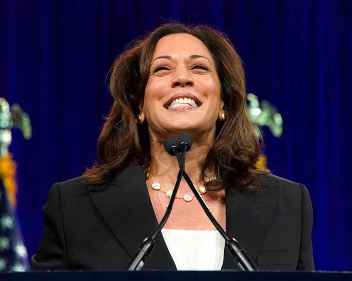Smiling woman speaking at podium with blue background.