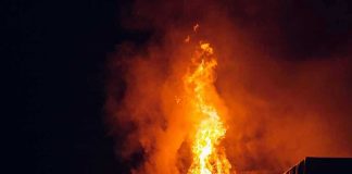 MOLOTOV ATTACK Shocks Famous AI CEO Building engulfed in large flames at night.