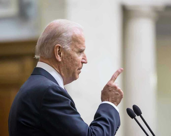 Man in suit pointing while speaking at podium.