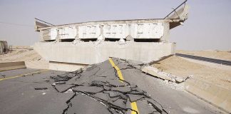 Severely damaged road and collapsed bridge due to earthquake