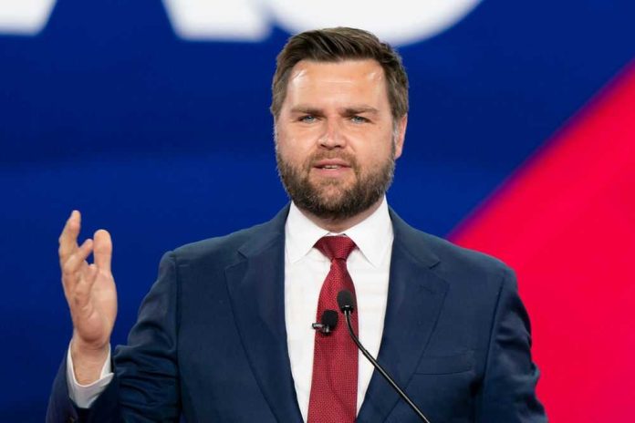 Man in a suit speaking at an event.