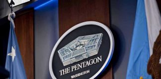 J6 Rioter Lands Pentagon TOP Job The Pentagon emblem between two flags.