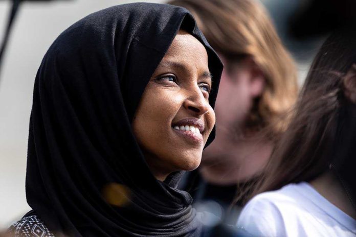 shutterstock_1369298651-1- A woman wearing a black hijab smiling at an outdoor event